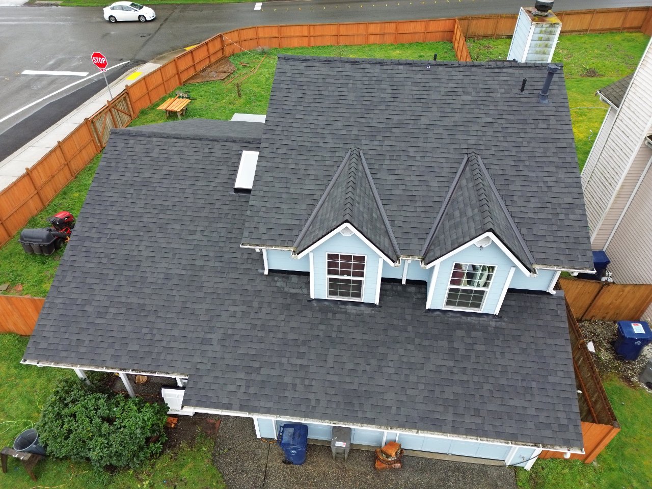 Finished architectural shingle roof on the same home with blue dormers